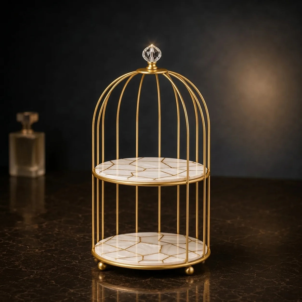 Vanity cage organizer in Pearl — white plates with a gold facet pattern, gold cage frame and crystal finial