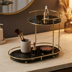 Free-standing two-tier organizer in Onyx holding brushes and cosmetics on a vanity