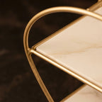 Close-up of the gold wire curve meeting the marble-effect tray