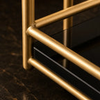 Close-up of the gold-finish rail and marble-effect shelf edge