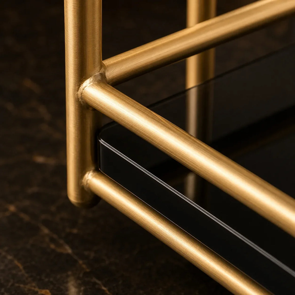Close-up of the gold-finish rail and marble-effect shelf edge