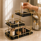 Modern stepped three-tier organizer in Onyx holding skincare and brushes on a vanity