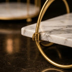 Close-up of the marble shelf passing through the gold ring frame