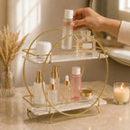A hand placing a bottle on the round two-tier organizer, showing its true size