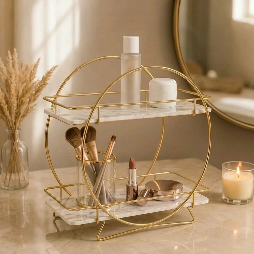Round two-tier organizer in Pearl holding brushes, lipstick and a compact on a marble counter